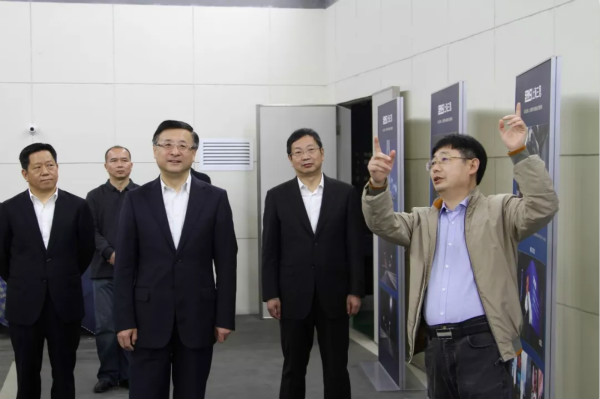 上海市委常委、市委政法委書記陳寅（中）、閔（mǐn）行區區委書記（jì）朱芝鬆（右二）、區委常委、政法委書記（jì）劉豫峰（左一）聽取上海大香蕉9草在线總裁王鷹華（右一）介紹（shào）LED相關技術和（hé）產品